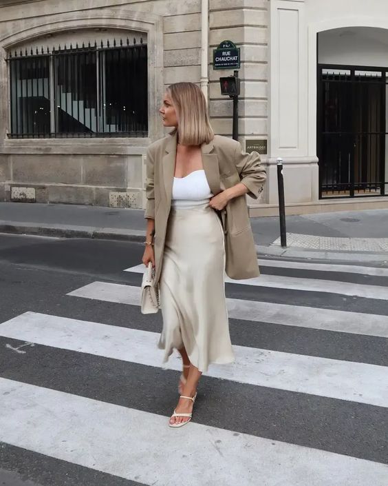 White cami top with a cream silk midi skirt